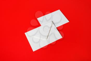 Blank paper envelopes on on red background. Front and back side.