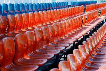 Empty red and blue stadium seats in perspective background
