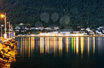 Night Tromso city pier with lamp reflections background hd