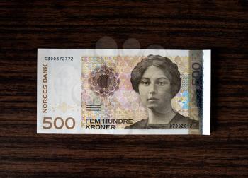 500 Norwegian krones face on wood desk background hd
