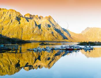 Horizontal vivid orange sunset in Norway fjords reflection landscape background backdrop