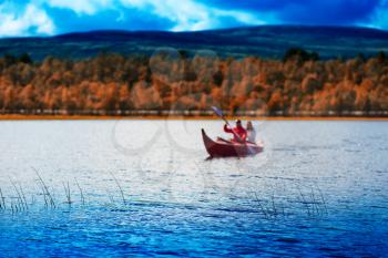 Couple of tourists swimming in autumn boat background hd