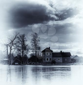 Vertical vintage vibrant blue sepia house on waters background backdrop