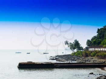 Horizontal vivid Indian beach quay with birds landscape background backdrop