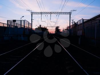 Symmetric two railway tracks during sunset background