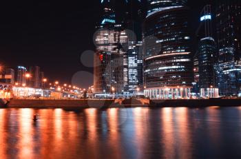 Right alighned Moscow city buildings on night river bank backdrop