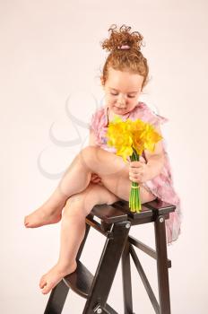 Fashion little girl in rose dress, in catwalk model pose, stock photo