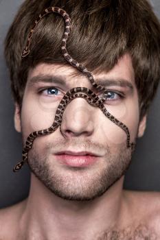 Portrait of a Young Handsome Man with Snake on His Face