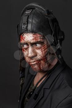 Portrait of Brutal Man with Creative Military Style Camouflage. Face Paint.  Close up on black background