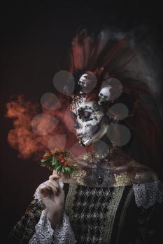 Santa Muerte Young Girl with Artistic Halloween Makeup and with Sculls in her Hair