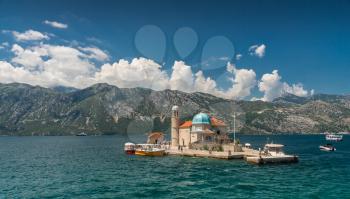Perast, Montenegro - 07.11.2018.  Our Lady of the Rocks church on an Island in the Bay of Kotor, Montenegro,  in a sunny summer day