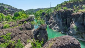Venetikos river with green water and  beautiful rock formations near Meteora in Greece