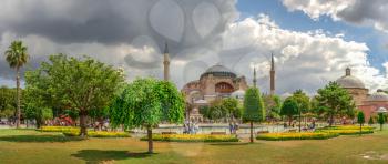 Istambul, Turkey – 07.12.2019. The Sultan Ahmad Maydan water fountain with the Hagia Sophia museum in background on a cloudy summer day, Istanbul, Turkey