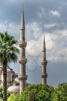 Istambul, Turkey – 07.12.2019. Minarets of the mosque of Hagia Sophia in Sultan Ahmed Park, Istanbul, Turkey, on a cloudy summer day