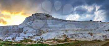 Pamukkale, Turkey – 07.14.2019. Pamukkale white Mountain. Panoramic view from the side of the village on a cloudy summer evening.