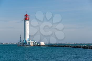 Odessa, Ukraine 06.06.2020. Lighthouse at the entrance to the harbor of Odessa seaport, on a sunny summer day