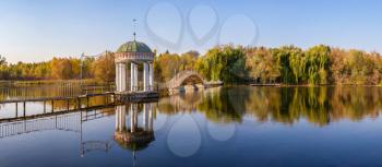 Gazebo in the middle of the lake on a sunny autumn evening in the village of Ivanki, Cherkasy region, Ukraine