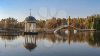 Gazebo in the middle of the lake on a sunny autumn evening in the village of Ivanki, Cherkasy region, Ukraine