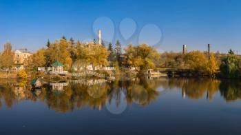 Autumn landscape with a lake and yellow trees in the village of Ivanki, Cherkasy region, Ukraine, on a sunny autumn evening