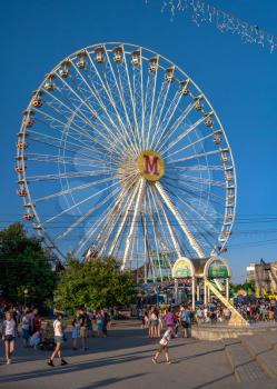 Berdyansk, Ukraine 07.24.2020. Ferris wheel on Berdyansk embankment, on a sunny summer evening