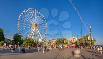 Berdyansk, Ukraine 07.24.2020. Ferris wheel on Berdyansk embankment, on a sunny summer evening