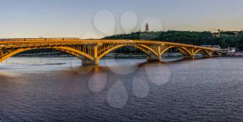 Kyiv, Ukraine 07.11.2020. Kyiv Metro bridge across the Dnieper river on a sunny summer evening.