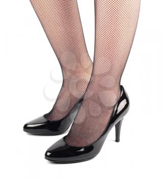 Girl legs in black patent leather female high heeled shoes isolated on white background