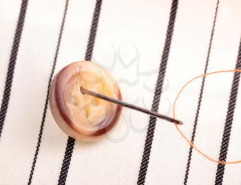 Sewing button on a cloth