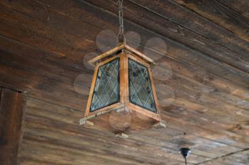 Ceiling lamp on the wooden ceiling. The frame light bulb.