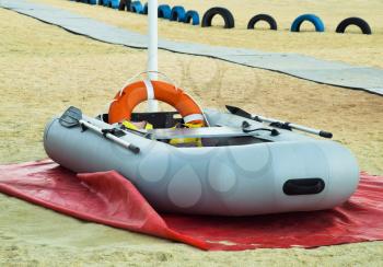 Inflatable Rescue Boat. Gray inflatable boat on the beach in the sand.