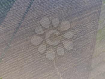 Top view of a plowed field. Background texture of the surface of the plowed field. Shooting with quadrocopters.