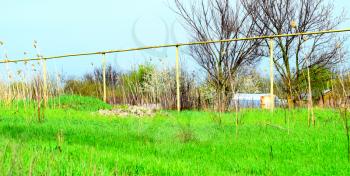 Gas pipe on the background of grass. Gas supply in the village.