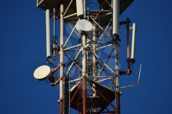 Satellite antennas and repeaters on the tower. Telecommunications.