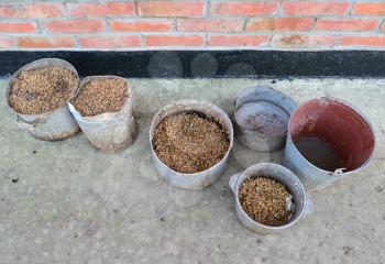 Boiled corn dirty pans. Poultry feed. Wheat cooked in the old pot