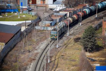 Krasnodar, Russia - February 23, 2017: Freight train traveling through the city buildings