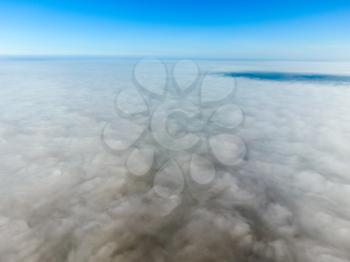 In the skies above the fog. Sunrise over the fog. Clouds near the ground.