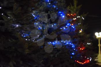 Night Christmas toys. Dressed Christmas tree on the street.