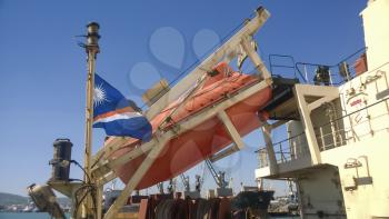 A lifeboat in case of an accident in the port or on a ship. The orange boat.