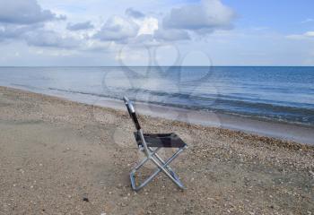 Folding chair by the sea. Convenience to the tourist. Rest by the sea