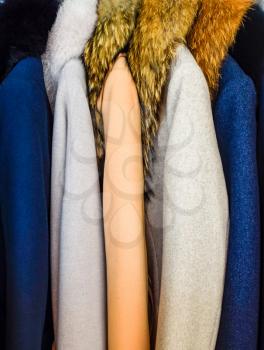 Coats and jackets on hangers in the store. Sale of outerwear