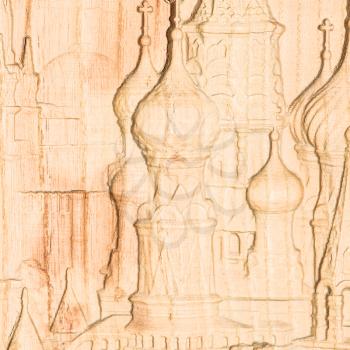 Woodcarving. Carved relief image of the Moscow Kremlin on a wooden plank.
