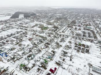 Winter view from the bird's eye view of the village. The streets are covered with snow.