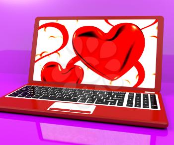 Red Hearts On Laptop Showing Love And Romance