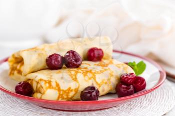 Sweet pancakes with cherry