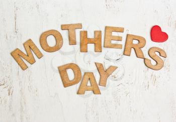  Mothers Day with wooden letters on an old white wooden background