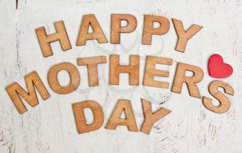 Happy Mothers Day with wooden letters on an old white wooden background