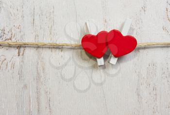 Two lovely red hearts. On old white wood background.