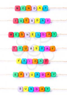 Days of the week, a weekly calendar from multi-colored cubes on a white background