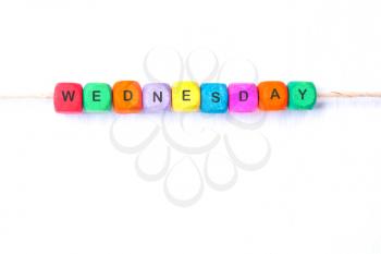 WEDNESDAY word of multicolored cubes on a white background