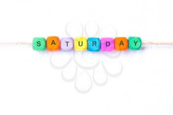 saturday word of multicolored cubes on a white background